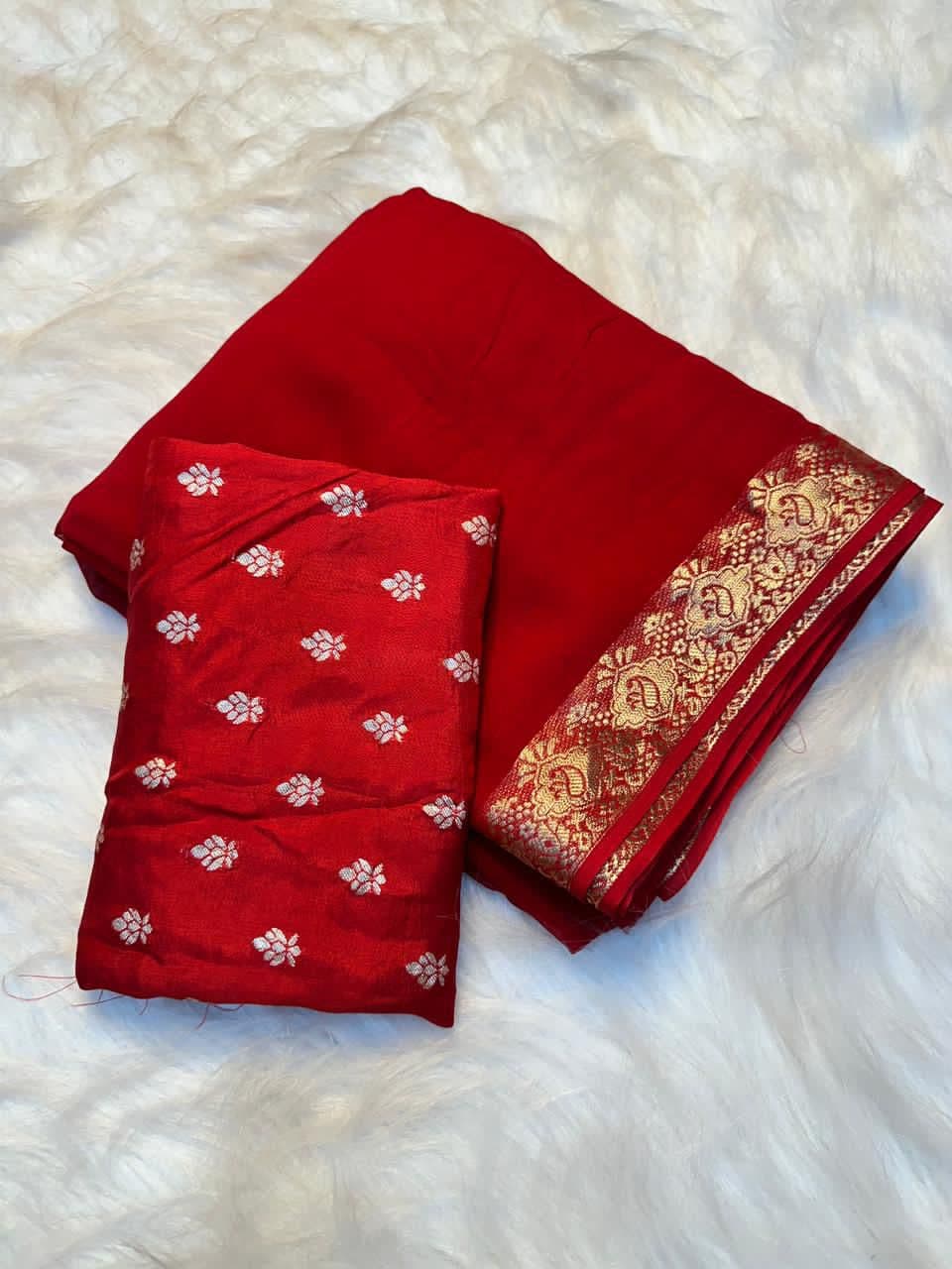 Orange-red silk saree with gold zari border and tassels
